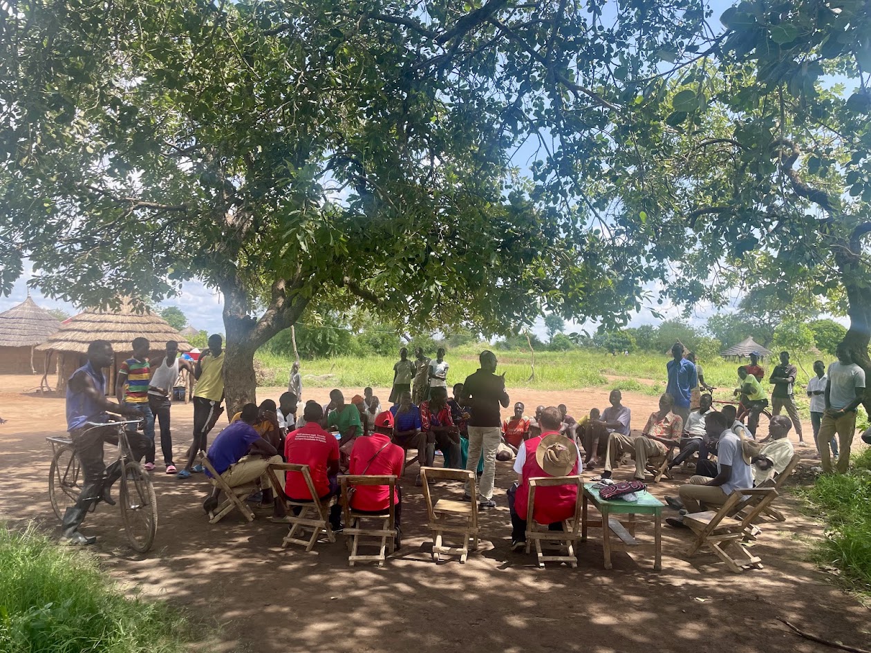Red Cross employees sit in a circle and discuss.